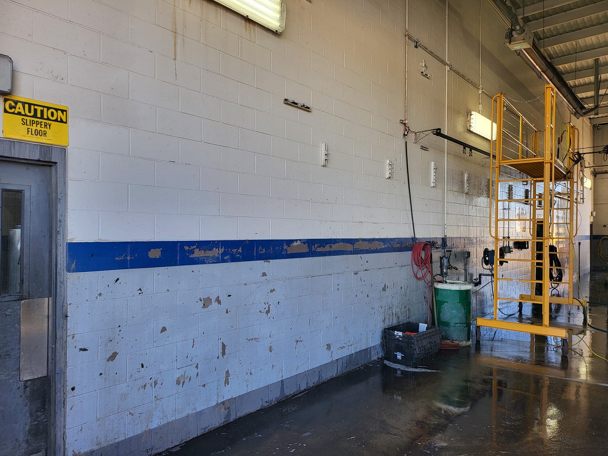 Auto shop service bay wall and floor clean after commercial pressure washing