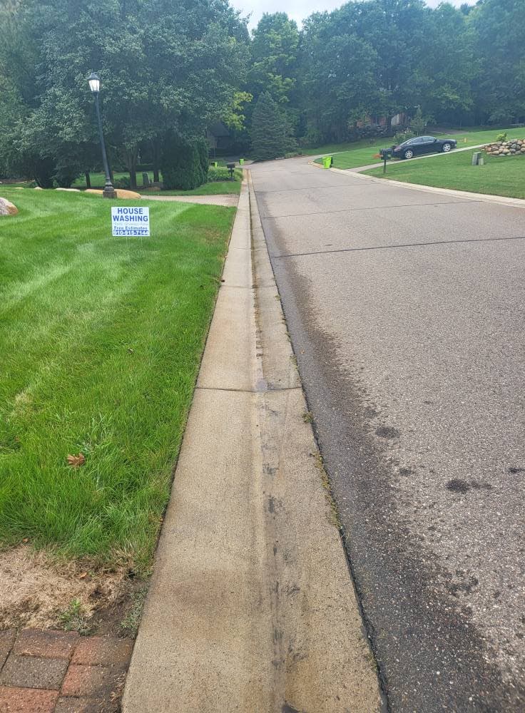 Neighborhood curbline and gutter edge brightened after HOA-focused cleaning