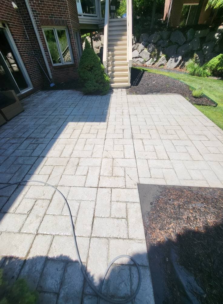 Paver patio surface brightened and cleaned after surface washing