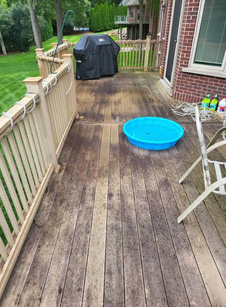 Composite deck boards with mildew spotting and weathering before cleaning