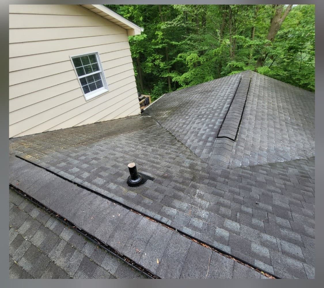 Shingle roof valley clean and restored after professional roof cleaning