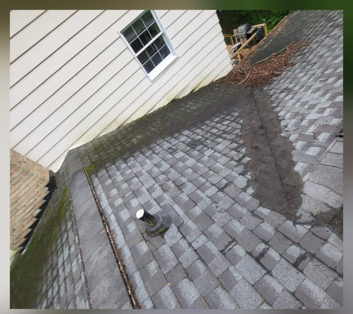 Shingle roof valley with dark runoff staining before soft wash