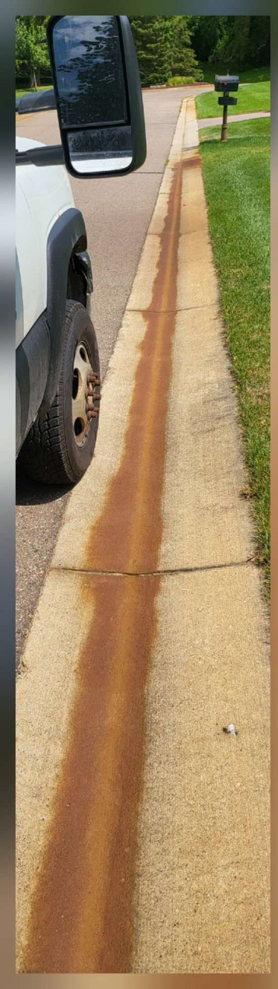 Curb with rust and heavy staining before cleaning